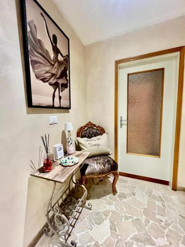 a living room with a table and a chair at La Teranga in Imola