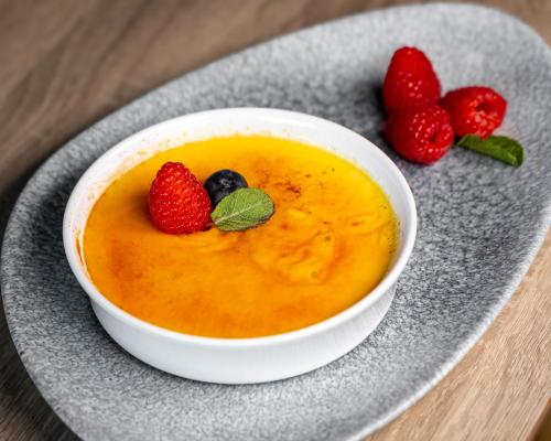 a bowl of soup with strawberries and blueberries on a plate at Holiday Inn London West by IHG in London