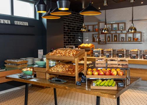 a bakery with bread and fruit on a table at Holiday Inn London West by IHG in London