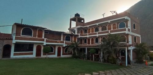 a large building with a clock tower on top of it at Hotel El Molle in Lunahuaná