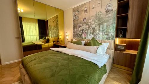 a bedroom with a bed with a large painting on the wall at The Royal Palace Luxury Suite by Sattal in Bucharest