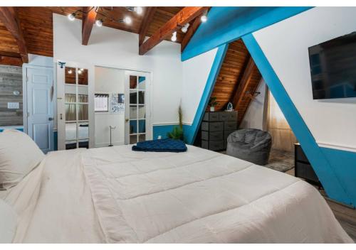 a bedroom with a large bed with a blue roof at Jones Beach Houseboat in Seaford
