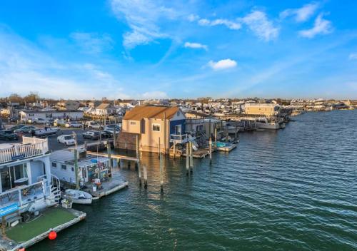 a marina with houses and boats on the water at Jones Beach Houseboat in Seaford