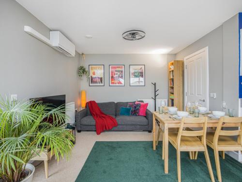 a living room with a table and a couch at Luxury Loft Living Free Parking - Pass the Keys in Brighton & Hove
