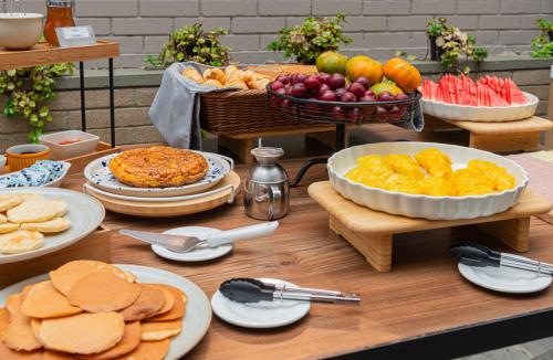 a table topped with lots of different types of food at Hotel Viaggio 617 in Bogotá
