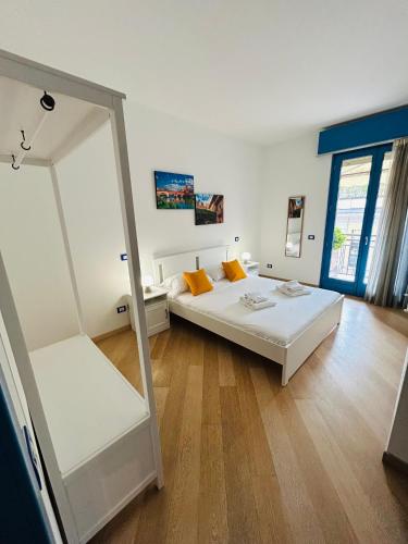 a bedroom with a large white bed and a mirror at Grazia Luxury Home in Verona
