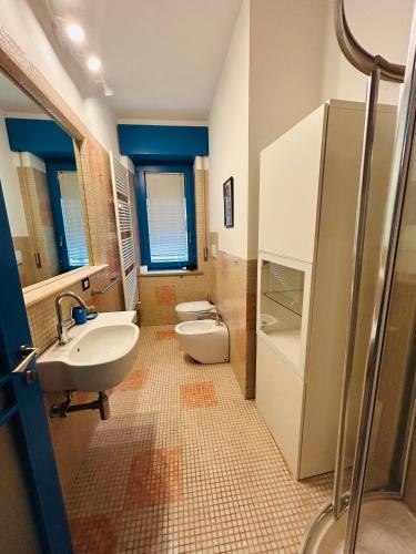 a bathroom with a sink and a toilet at Grazia Luxury Home in Verona