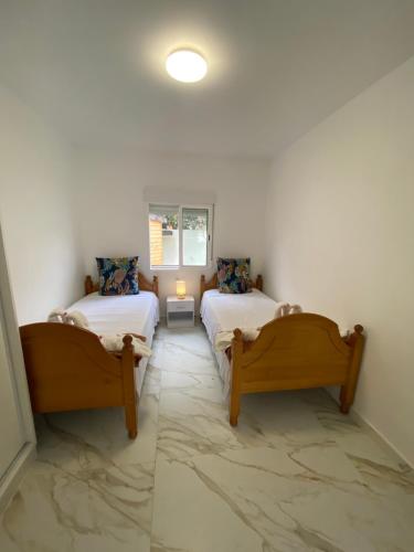 a room with two beds and a window at REQUESENS Playa in Empuriabrava