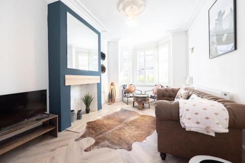 a living room with a couch and a television at Western House - Central Warrington - Sleeps 5 in Warrington