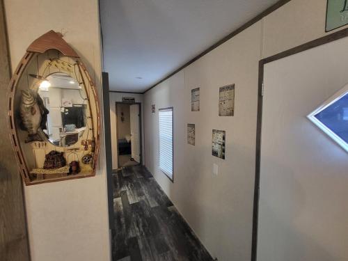 a room with a hallway with a mirror at The Tackle Box in Many