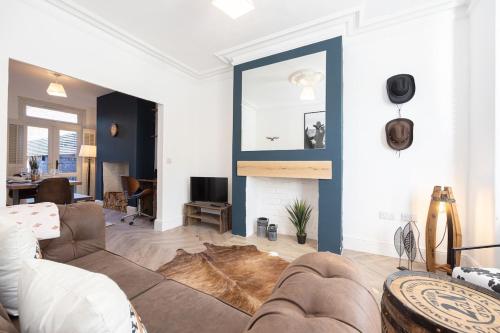 a living room with a couch and a fireplace at Western House - Central Warrington - Sleeps 5 in Warrington