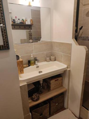 une salle de bain avec un lavabo et un miroir dans l'établissement Charmant appartement Noailles Quartier typique et populaire du centre de Marseille, à Marseille