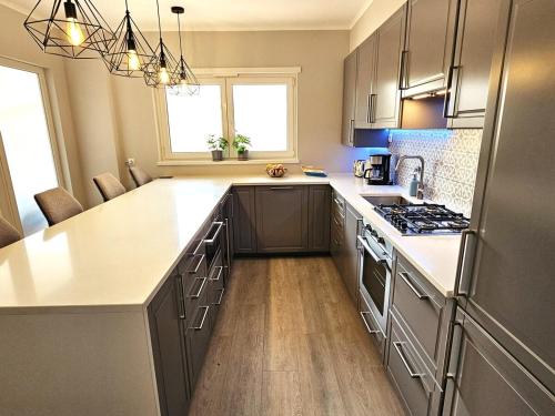a kitchen with stainless steel appliances and a counter top at Oasis Apartment by Sesimbra Sun Sea in Sesimbra