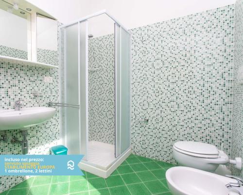 a bathroom with a shower and a toilet and a sink at RS320 - Marcelli, bilocale in residence fronte mare 1p in Marcelli