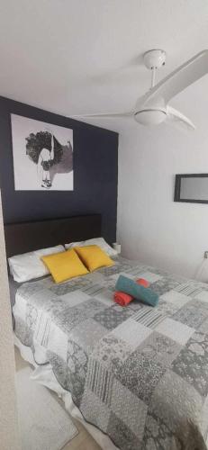 a bedroom with a bed with a quilt on it at Vistabella golf villa jade in Orihuela Costa