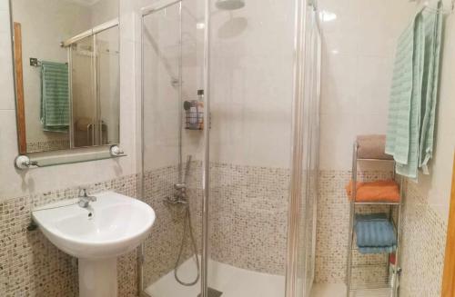 a bathroom with a sink and a glass shower at Vistabella golf villa jade in Orihuela Costa