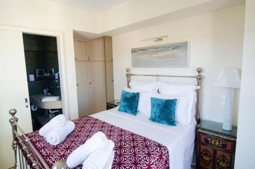 a bedroom with a bed with white and blue pillows at Limnos Experience in Mirina