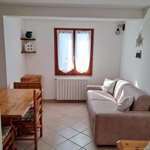 a living room with a couch and a table at La Casa del Sole in Carrodano Inferiore