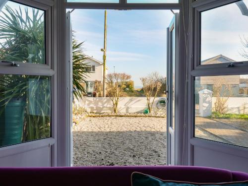 an open window with a view of a yard at Marine House in Pevensey
