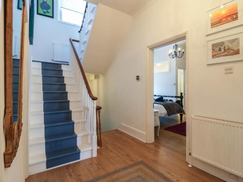 a staircase in a home with a blue and white stair case at Marine House in Pevensey