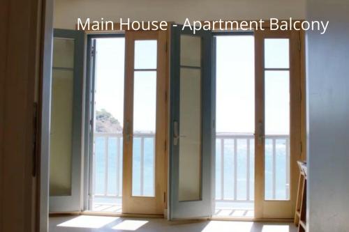 two doors in a room with a view of the ocean at Limnos Experience in Mirina