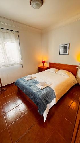 a bedroom with a large bed in a room at Cabana Fersan in Cabanas de Tavira