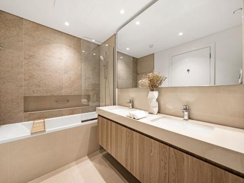 a bathroom with two sinks and a mirror at Blissful Stays - Luxury Two Bedroom Apartment at Downtown Views II- 5 min walk to Dubai Mall, Burj Khalifa with Infinity Pool in Dubai