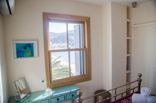 a window in a room with a table and a table sidx sidx sidx at Limnos Experience in Mirina