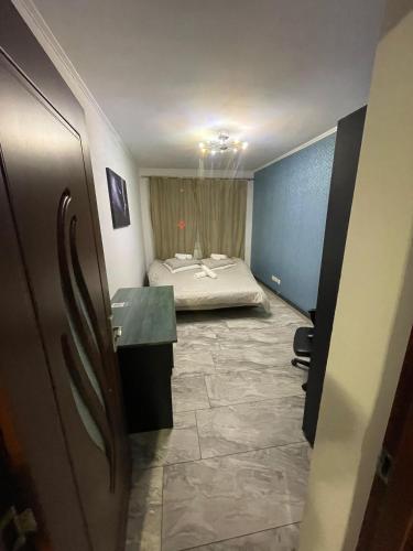 a room with a bed and a desk in it at Home away from home in Sighetu Marmaţiei