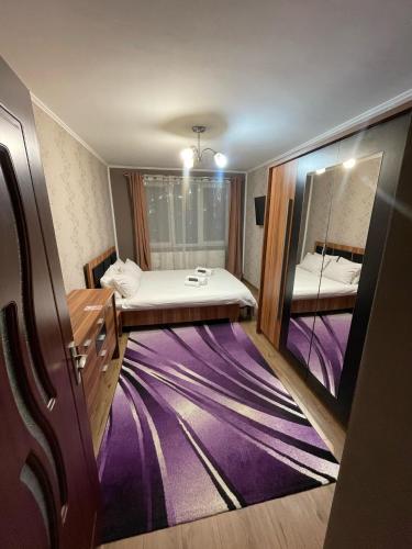 a small room with a bed and a mirror at Home away from home in Sighetu Marmaţiei