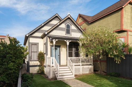 a small house with a white porch and stairs at Victorian Retreat in Barrio Logan 1mi to Downtown in San Diego