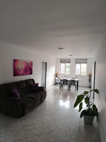 a living room with a couch and a table at Hotel Bayadera Real in Medellín