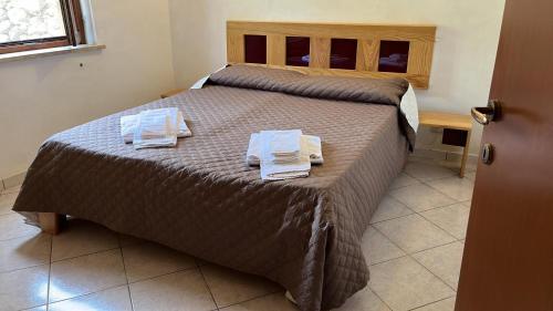 a bedroom with a bed with two towels on it at Il GIARDINO della FALENA in Favignana