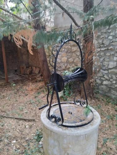 a black phone sitting on top of a bucket at Vitina Number 5 House in Vitina