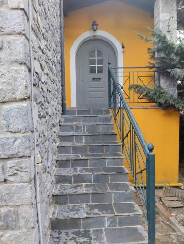 a stairway leading up to a yellow door at Vitina Number 5 House in Vitina