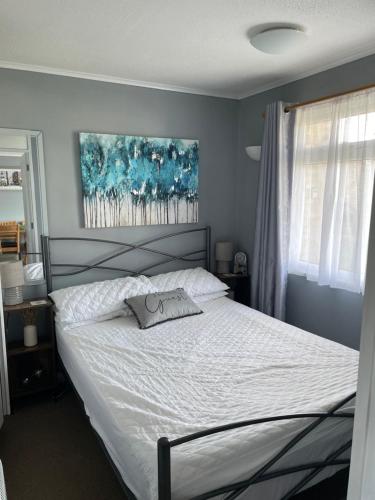 a bedroom with a bed with a pillow on it at 82, Sunbeach Holiday Park, California Rd, California, Great Yarmouth NR29 3QL in Scratby