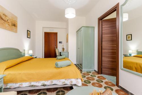 a bedroom with two beds and a mirror at Luna e stelle in Sangineto