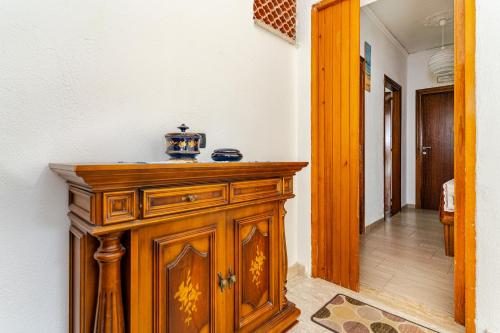a wooden cabinet in a room with a hallway at Luna e stelle in Sangineto
