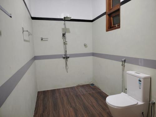 a bathroom with a toilet and a shower at Cloud9 villa weligama in Weligama