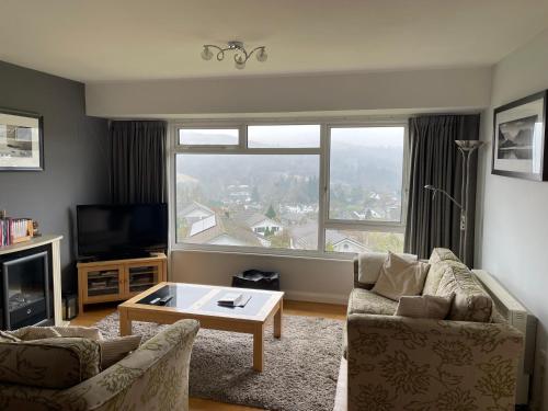 a living room with a couch and a coffee table at Ambleside 3 Bedroom Apartment in Ambleside