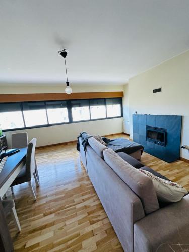 a living room with a couch and a fireplace at Big House in Vila Nova de Gaia