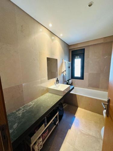 a large bathroom with a sink and a bath tub at Big House in Vila Nova de Gaia