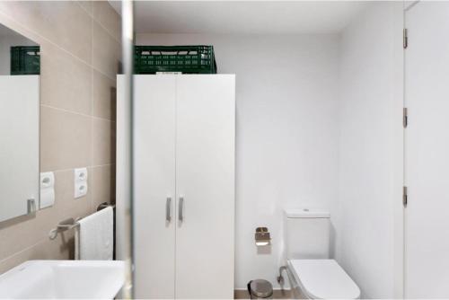 a white bathroom with a toilet and a sink at Abades confort & luxury in Abades