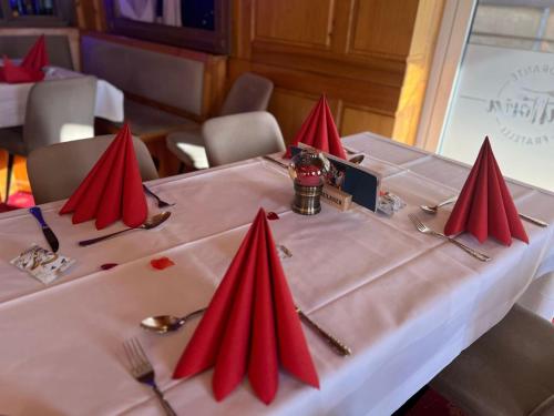 a table in a restaurant with red napkins on it at Hotel Schloßblick Trebsen in Trebsen