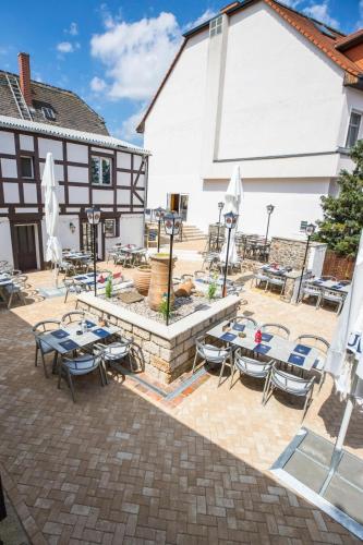 a patio with tables and chairs in front of a building at Hotel Schloßblick Trebsen in Trebsen