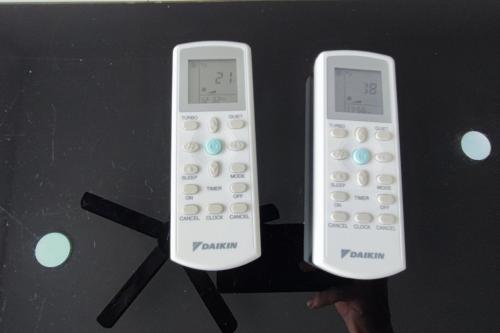 two remote controls are sitting on a stand at Cozy Corner at EduSentral by HCK in Shah Alam
