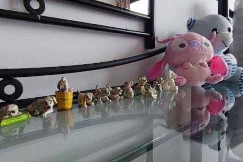 a glass shelf with toy animals on it at Cozy Corner at EduSentral by HCK in Shah Alam