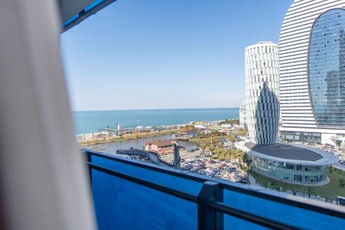 a view of the ocean from a balcony of a building at Orbi City Hotel D1 Block in Batumi
