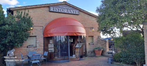 a brick building with a sign for a restaurant at Hotel More di Cuna in Monteroni dʼArbia