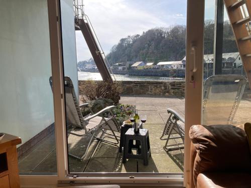 a room with a sliding glass door with a view of a train at 48A South Snowdon Wharf in Porthmadog